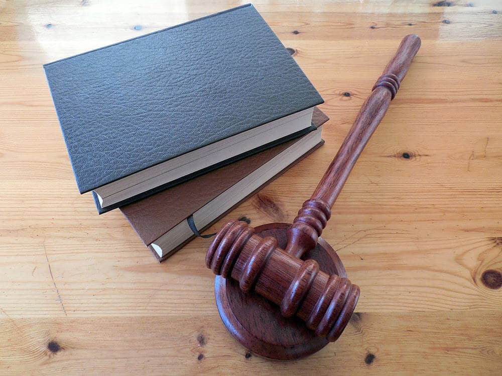 Books next to gavel on table 