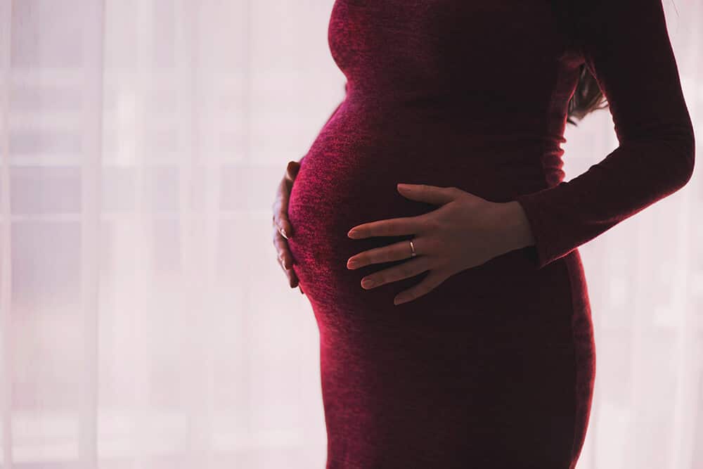 Pregnant woman holding stomach