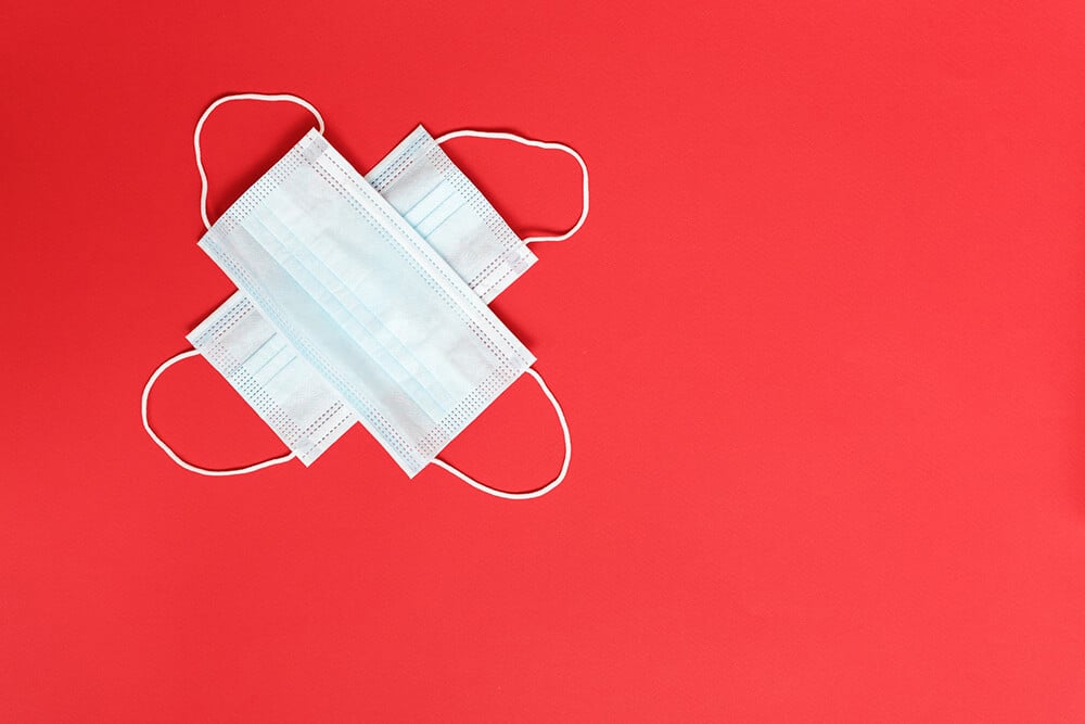 two masks on red background