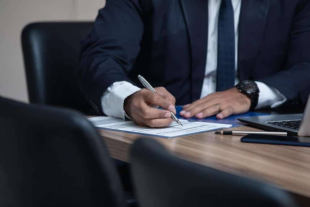 Person signing paper